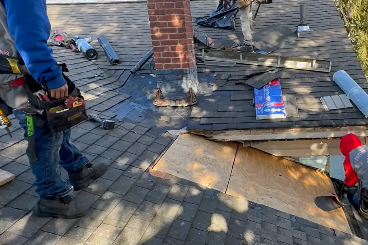 Asphalt shingle roof with damaged shingles removed before repair